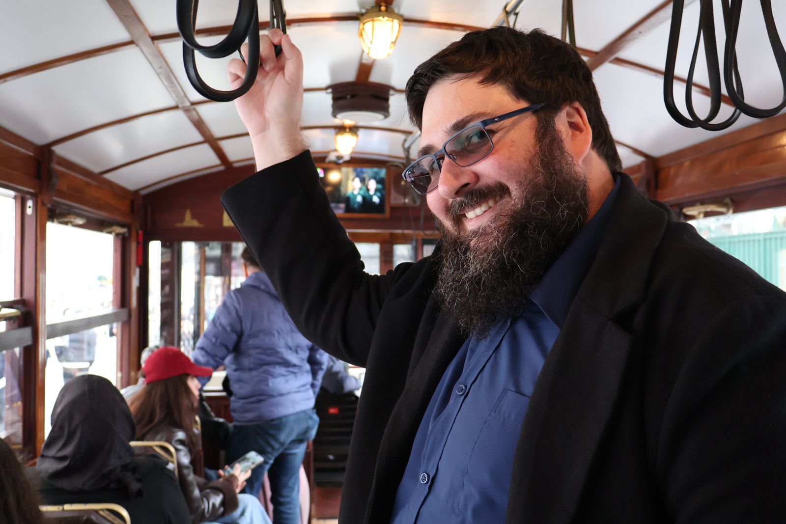 Beardy, smiling on a vintage tram